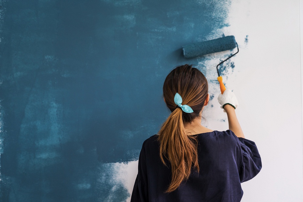 Woman Painting Wall Muted Blue