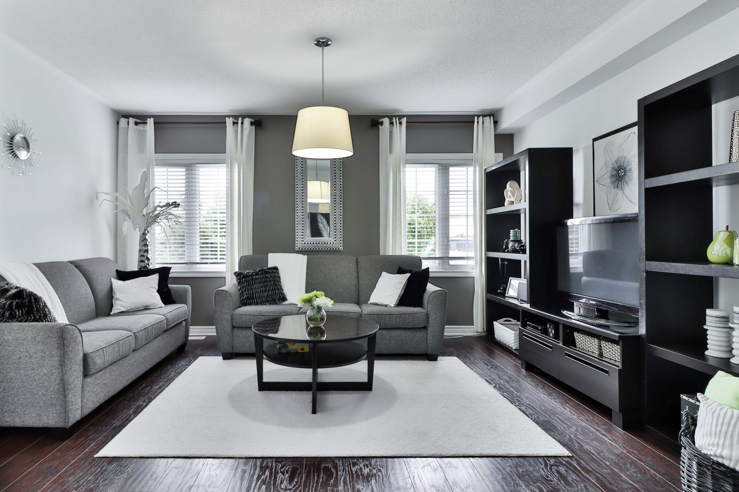 A modern living room with a gray accent wall
