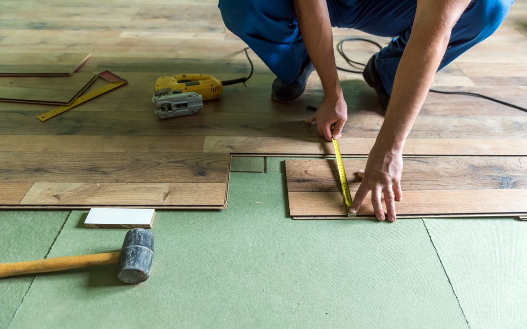 Man completes laminate flooring installation